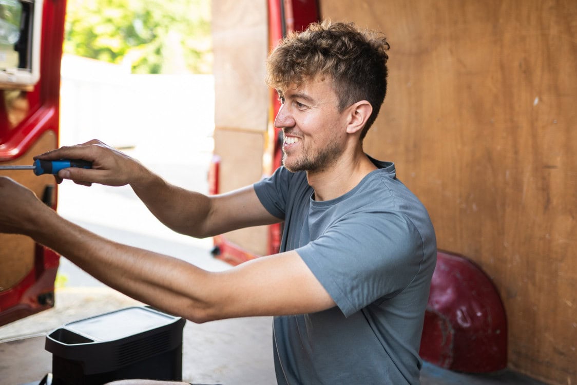 Finbus founder Maximilian Lichter at work in a camper.
