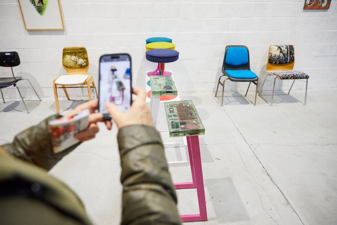 Someone taking pictures of colorful chairs.